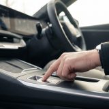Diese Nahaufnahme vermittelt die ruhige Präzision und moderne Technik beim ersten Schritt der Prüfung der elektrischen Parkbremse und erzeugt Vertrauen und Konzentration.